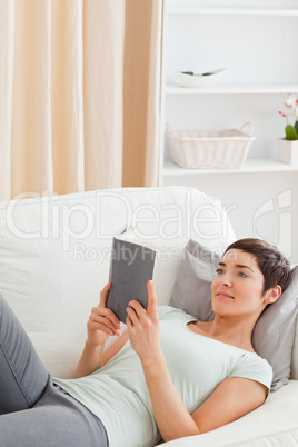 Portrait of a beautiful brunette reading a book