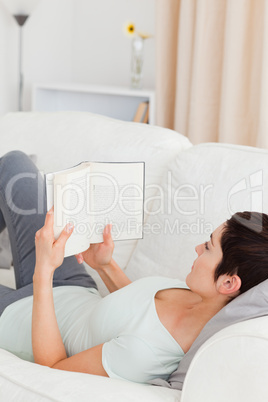 Short-haired woman reading a book