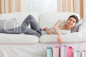 Young woman looking into shopping bags