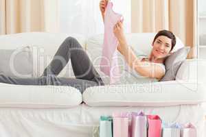 Woman showing a T-shirt she just bought