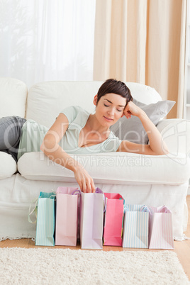 Young woman looking into shopping bags