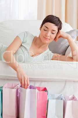 Portrait of a lovely woman loooking into shopping bags