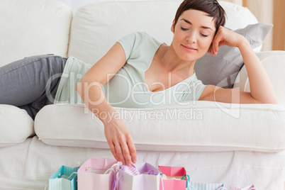 Close up of a lovely woman looking into shopping bags