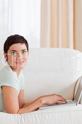 Portrait of a  cute short-haired woman with a laptop