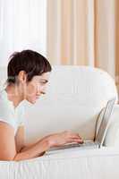 Portrait of a cute short-haired woman using a laptop