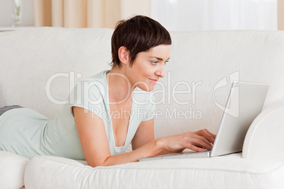 Happy short-haired woman using a laptop