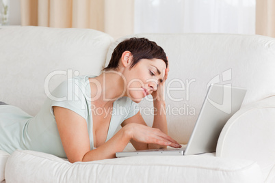 Tired woman using a laptop