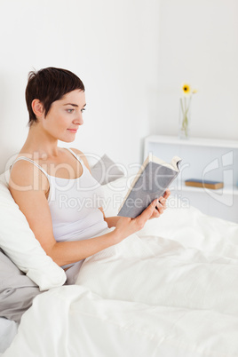 Portrait of a young woman reading a book