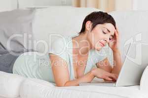 Upset young woman using a laptop
