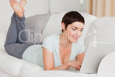 Smiling short-haired woman using a laptop