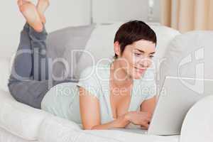 Smiling short-haired woman using a laptop