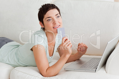 Pensive woman buying online