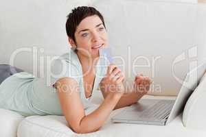 Pensive woman buying online