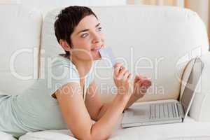 Pensive young woman buying online