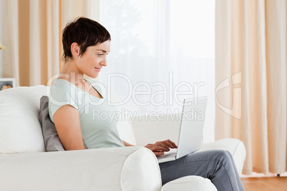 Short-haired woman working with a laptop