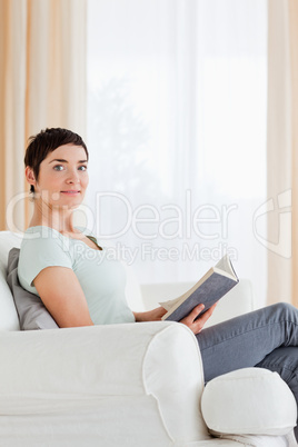 Portrait of a short-haired woman holding a book