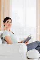 Portrait of a short-haired woman holding a book