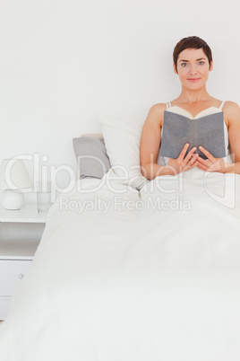 Portrait of a brunette holding a book