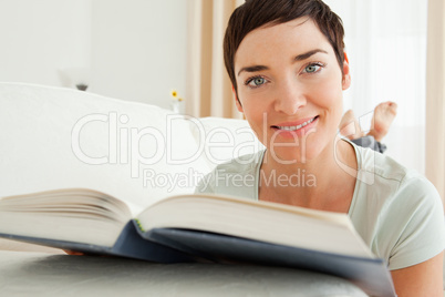 Close up of a short-haired woman with a book