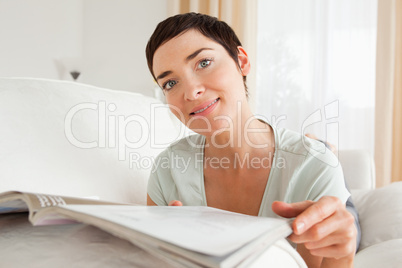 Cute woman reading a magazine