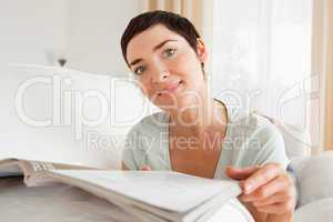 Cute woman reading a magazine