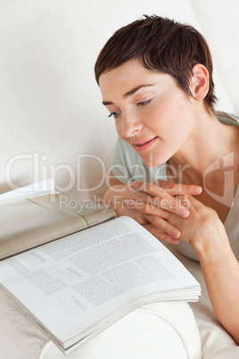 Portrait of a smiling woman reading a magazine