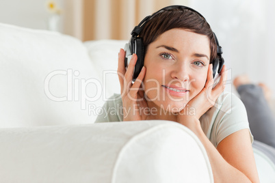 Close up of a short-haired brunette listening to music