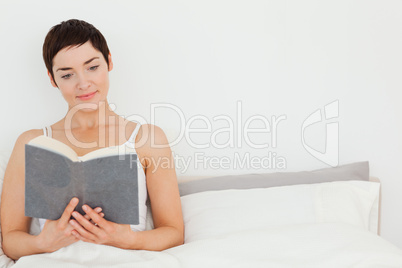 Close up of a brunette reading a book