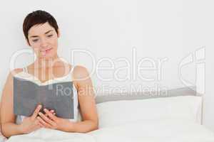 Close up of a brunette reading a book