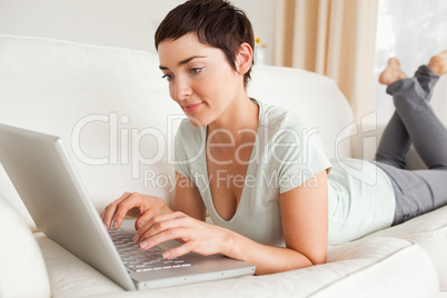 Gorgeous short-haired woman using a laptop