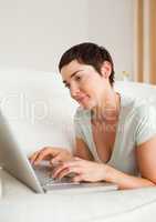 Portrait of a gorgeous short-haired woman using a laptop