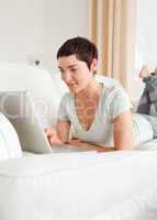 Portrait of a happy short-haired woman using a laptop