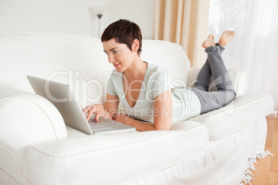 Happy short-haired woman using a laptop