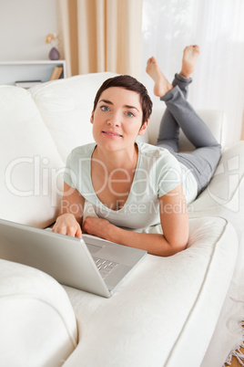 Portrait of a dark-haired woman with a laptop