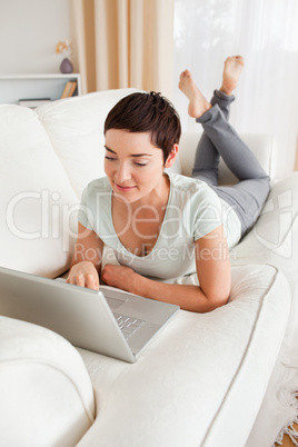Portrait of a dark-haired woman using a laptop