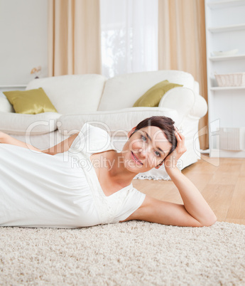 Quiet woman lying on a carpet