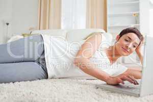 Quiet woman relaxing with a laptop