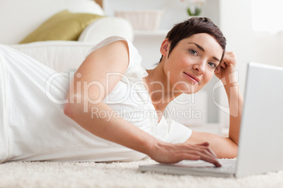 Close up of a quiet woman with a laptop