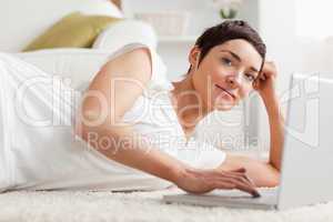 Close up of a quiet woman with a laptop