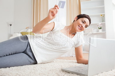 Brunette using her credit card to pay online