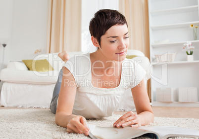 Cute brunette reading a magazine