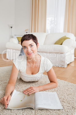 Portrait of a cute brunette with a magazine