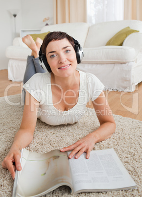Portrait of a woman with a magazine enjoying some music
