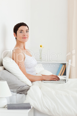 Portrait of a cute woman using a laptop