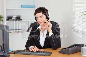 Serious secretary calling with a headset