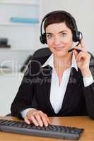 Portrait of a serious secretary calling with a headset