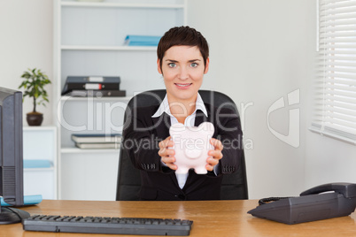 Office worker holding a piggybank