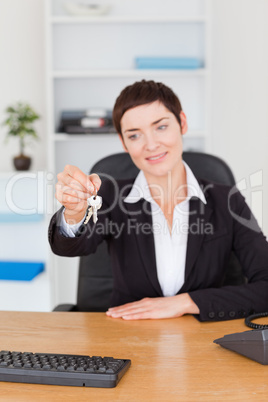 Portrait of an office worker showing keys