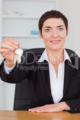 Portrait of a smiling secretary showing keys