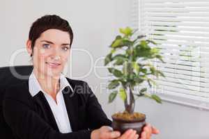 Secretary holding a plant